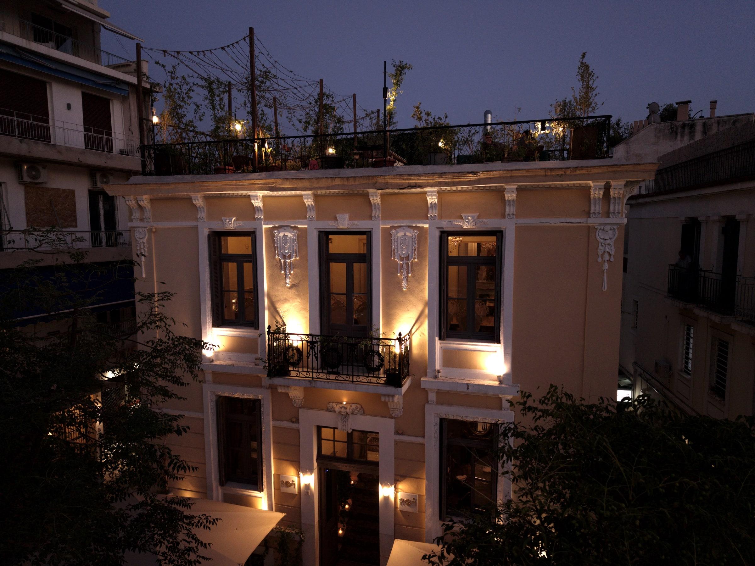 The neoclassical facade of ROI at dusk, every window lit